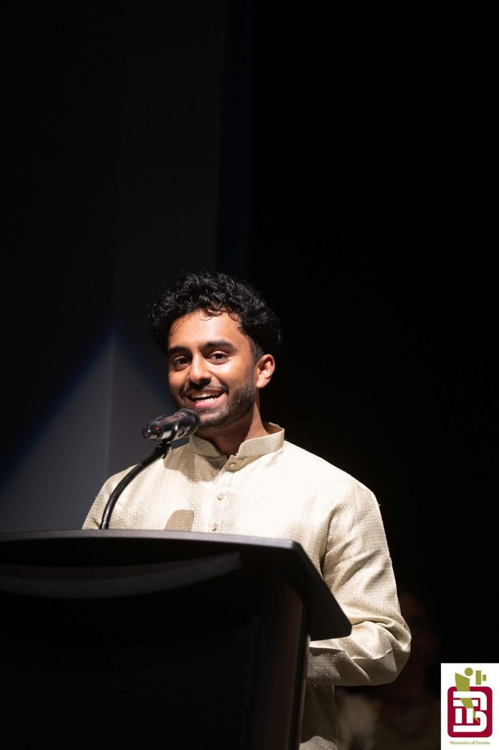 Rahgull Manoragavan speaking at podium