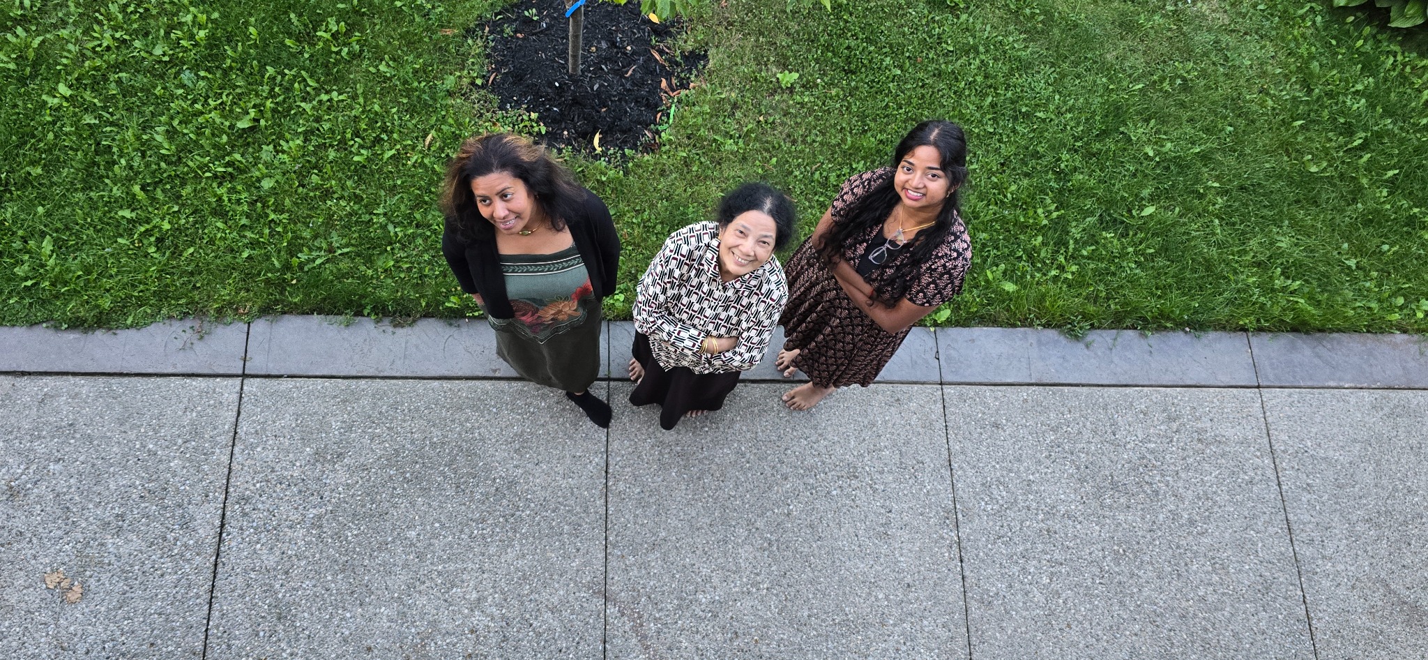 Family members outdoors smiling up to the camera